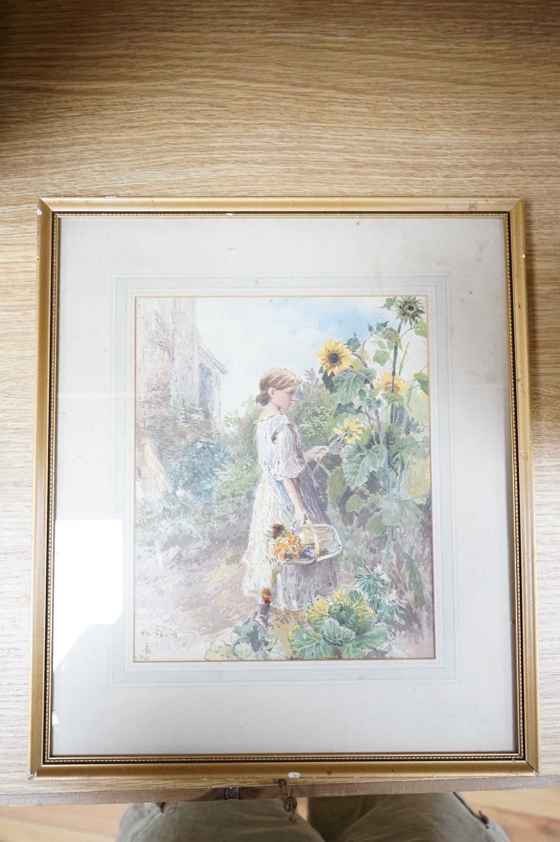Early 20th century watercolour, Young girl picking flowers, indistinctly monogrammed, 24 x 19cm. Condition - fair, would benefit from a clean